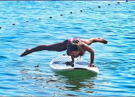 girl doing yoga on a paddleboard
