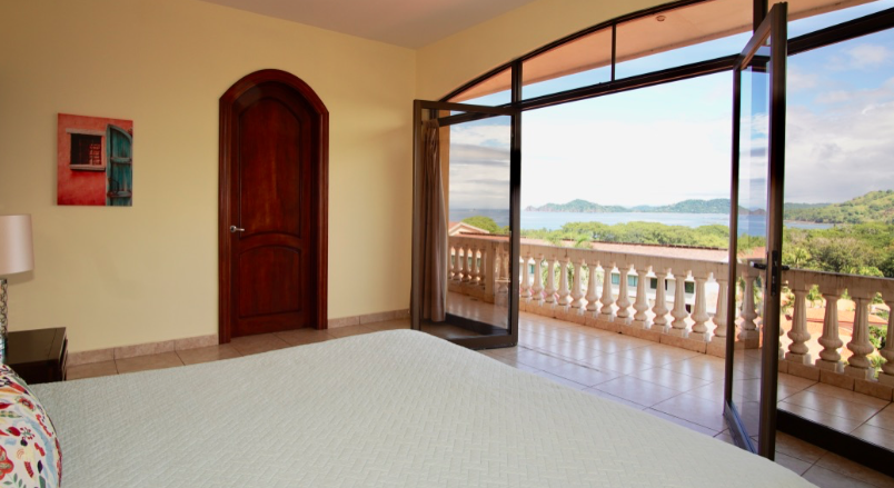 view of the Pacific Ocean from the bedroom of a luxury home in Costa Rica