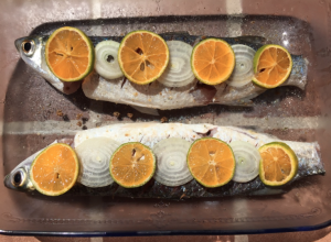 Healthy fish meal with oranges and onions